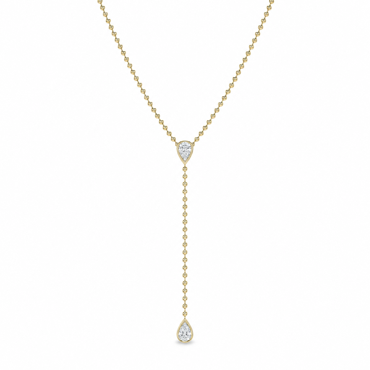 A delicate yellow gold Y-necklace featuring a pear-cut clear gemstone at the center and a longer drop chain ending in a teardrop-shaped clear gemstone, shown against a plain white background.