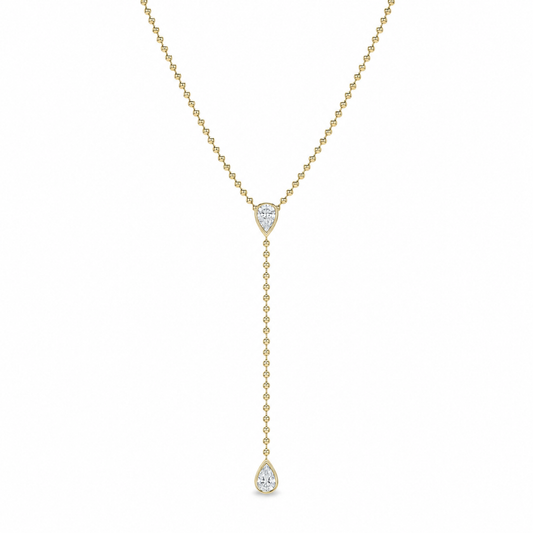 A delicate yellow gold Y-necklace featuring a pear-cut clear gemstone at the center and a longer drop chain ending in a teardrop-shaped clear gemstone, shown against a plain white background.